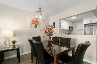 a dining room and kitchen with a table and chairs at 2 Bedroom 2 Bath With Patio On 11th Collins ave in Miami Beach