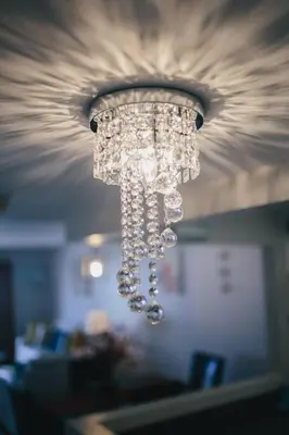 a chandelier with crystals hanging from a ceiling at 2 Bedroom 2 Bath With Patio On 11th Collins ave in Miami Beach