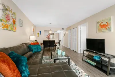 a living room with a couch and a flat screen tv at 2 Bedroom 2 Bath With Patio On 11th Collins ave in Miami Beach
