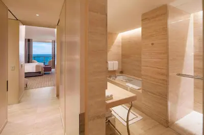 a hotel room with a bathroom with a shower at The St. Regis Bal Harbour Resort in Miami Beach