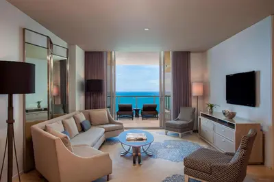 a living room with a couch and a table at The St. Regis Bal Harbour Resort in Miami Beach