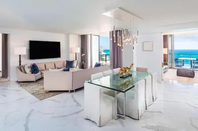 a living room with a couch and a table at The St. Regis Bal Harbour Resort in Miami Beach