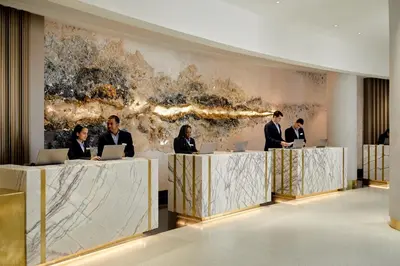 a group of people sitting at a table with laptops at Loews Miami Beach Hotel in Miami Beach