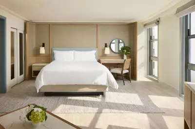 a bedroom with a large bed and a desk at Loews Miami Beach Hotel in Miami Beach