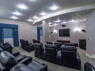 a conference room with leather chairs and a flat screen tv at The Tides Miami in Miami