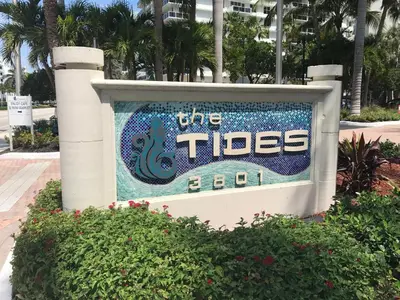 a sign for the tides hotel with trees in the background at The Tides Miami in Miami
