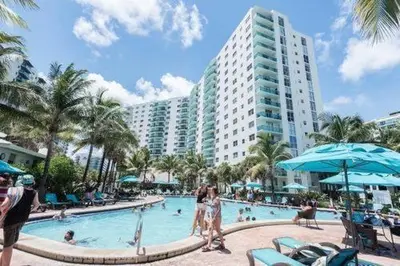 a resort swimming pool with people in a hotel at The Tides Miami in Miami