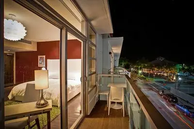 a balcony of a hotel room with a bed at Prime Hotel Miami in Miami Beach