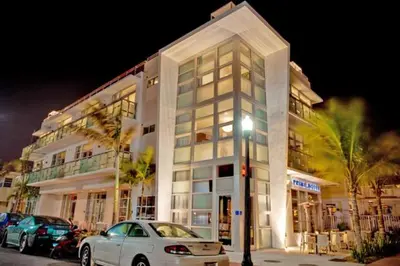 a white car parked in front of a building at Prime Hotel Miami in Miami Beach