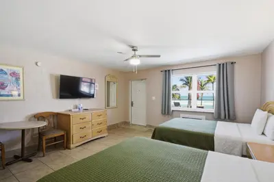 a hotel room with two beds and a television at La Terrace Oceanfront in Hollywood