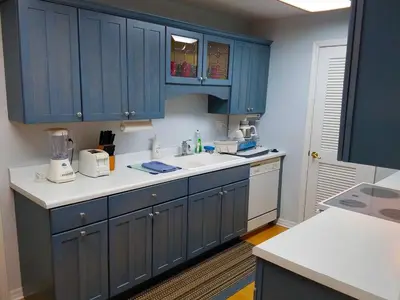 a kitchen with blue cabinets and a white sink at Large Lush Oasis Paradise by FLL Beach and Galleria - 2bd 2ba in Fort Lauderdale