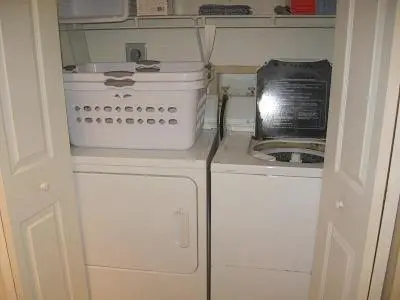 a small kitchen with a stove and a appliance at Resort Style In Aventura Florida in Aventura