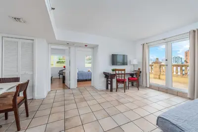 a bedroom with a table and chairs and a dining room at SoBe Lux Suites On Ocean in Miami Beach