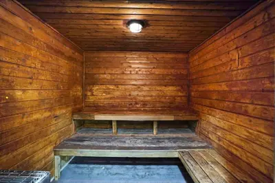 an empty wooden sauna with a bench in it at StayCozy Apartments at The Grand in Miami