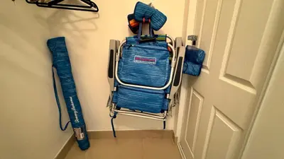 a rack with a baseball bat and gloves on a door at Sunny Isles Condo Resort in Miami Beach
