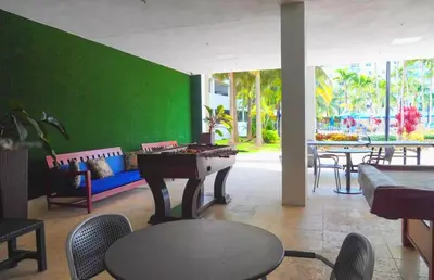 a room with a ping pong table and a green wall at Sunny Isles Condo Resort in Miami Beach