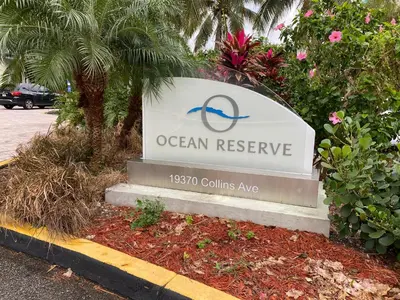 a sign for an ocean reserve in a parking lot at Sunny Isles Condo Resort in Miami Beach