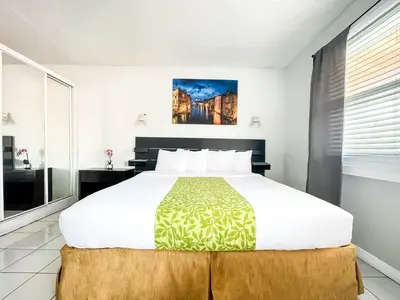 a bedroom with a large bed and a window at The Swan in Hollywood