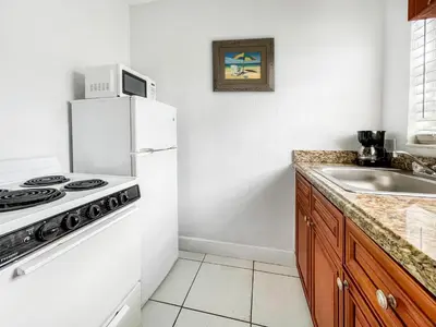 a kitchen with a white refrigerator and a sink at The Blue Wave in Hollywood