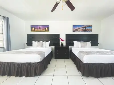 a bedroom with two beds and a ceiling fan at The Blue Wave in Hollywood