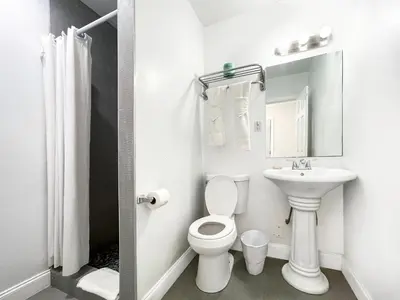 a white bathroom with a toilet and a sink at The Seagull in Hollywood