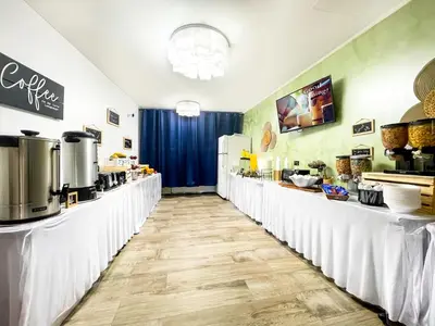 a restaurant with white tables and a counter with food at Hollywood Beach Seaside in Hollywood