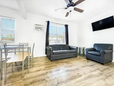 a living room with chairs and a table and a ceiling fan at Hollywood Beach Seaside in Hollywood