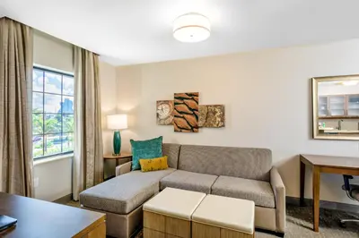 a living room with a couch and a table at Staybridge Suites - Fort Lauderdale Airport - West by IHG in Davie
