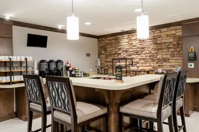 a bar in a restaurant with chairs and a counter at Staybridge Suites - Fort Lauderdale Airport - West by IHG in Davie