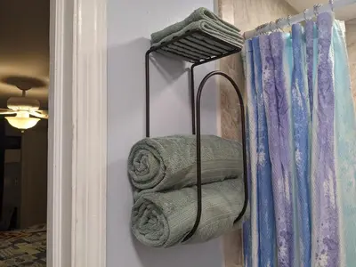 a towel rack with towels hanging on a wall at The Blue Door Inn in Fort Lauderdale