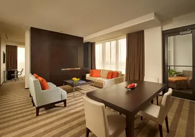 a living room with a table and chairs and a couch at EB Hotel Miami Airport in Miami