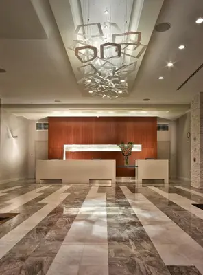 a lobby with a ceiling with a chandelier at EB Hotel Miami Airport in Miami