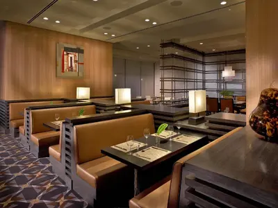a dining room with tables and chairs and a restaurant at EB Hotel Miami Airport in Miami