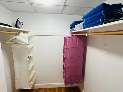 a walk in closet with white walls and purple organizers at Miami Hollywood Great 2 Bedroom 2 Bathroom with Intercostal View 001-22bvic in Hollywood