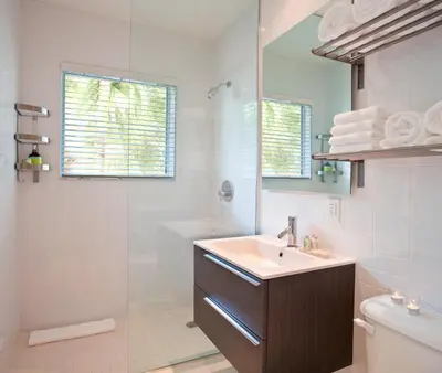 a bathroom with a sink and a shower and a toilet at 1818 Meridian House Apartments and Suites by Eskape Collection in Miami Beach
