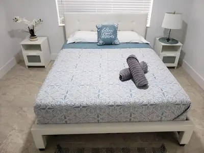 a bedroom with a bed with two pillows on it at Apts with Backyard Near Fort Lauderdale Beach, Nightlife, Cruise Port, Airport in Fort Lauderdale