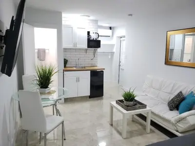 a living room with a white couch and a table at Apts with Backyard Near Fort Lauderdale Beach, Nightlife, Cruise Port, Airport in Fort Lauderdale