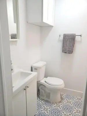 a white bathroom with a toilet and a sink at Apts with Backyard Near Fort Lauderdale Beach, Nightlife, Cruise Port, Airport in Fort Lauderdale