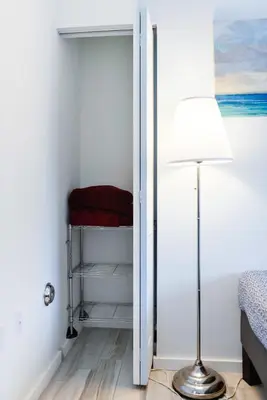 a room with a door with a lamp and a bed at Amazing 2 BR Condo At Wynwood With Parking in Miami