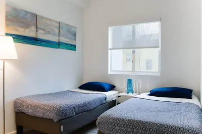 two beds in a small room with a window at Amazing 2 BR Condo At Wynwood With Parking in Miami