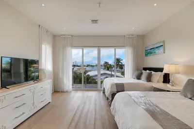 a white bedroom with two beds and a large window at Modern villa w lake view heated pool grill in Hollywood