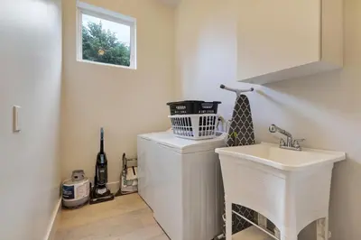 a white bathroom with a sink and a window at Modern villa w lake view heated pool grill in Hollywood