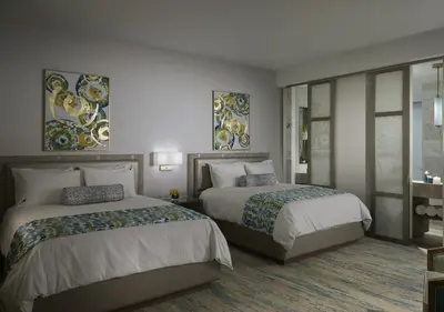 two beds in a hotel room with two bedsskirtspectspectspectssenalsenalsenal at The Guitar Hotel at Seminole Hard Rock Hotel & Casino in Fort Lauderdale