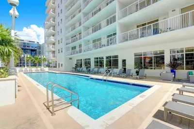 a swimming pool in front of a building at Beautiful Apartments in Miami Brickell in Miami