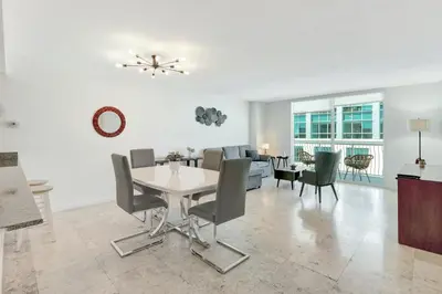 a dining room and living room with a table and chairs at Beautiful Apartments in Miami Brickell in Miami