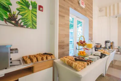 a breakfast buffet with bread and pastries on a table at Penguin Hotel in Miami Beach