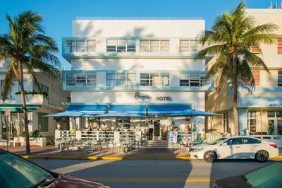 a white car parked in front of a building at Penguin Hotel in Miami Beach