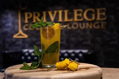 a drink sitting on top of a wooden table at Albion Hotel in Miami Beach