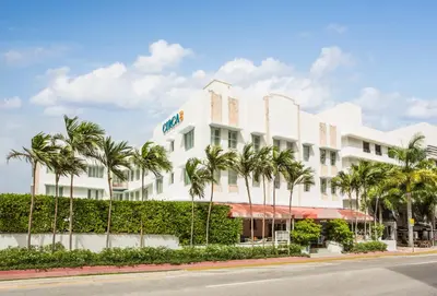 a building with palm trees in front of a street at Circa 39 Miami Beach in Miami Beach