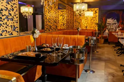 a restaurant with a table with a tray of food at Colony Hotel in Miami Beach